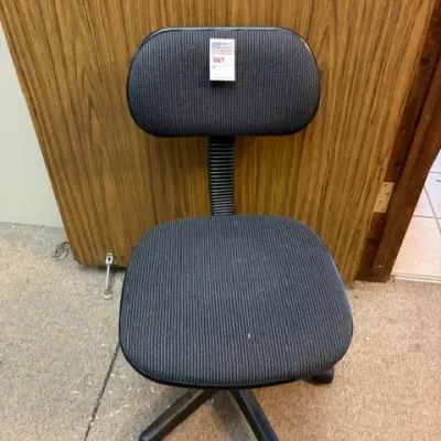 Vintage armless office task chair with charcoal gray ribbed fabric upholstery and a rolling five-star base.