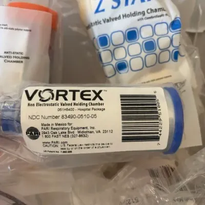 Collection of packaged medical respiratory equipment, including a PARI Vortex non-electrostatic valved holding chamber.