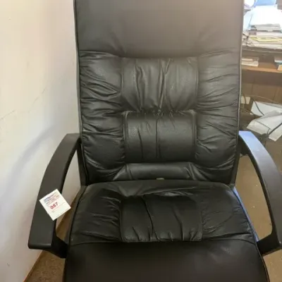 Black faux leather high-back executive desk chair featuring padded armrests and a tufted seat and backrest.