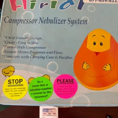 Vintage Airial pediatric compressor nebulizer system in original box with child-friendly penguin design.