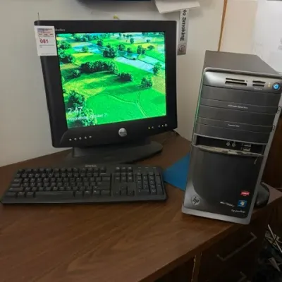HP Pavilion desktop computer tower paired with a Dell UltraSharp LCD monitor and matching Dell keyboard, circa late 2000s.