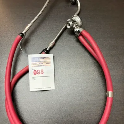 Vintage dual-tubing stethoscope with a chrome-plated chestpiece and red flexible tubing, marked with auction lot tag 098.