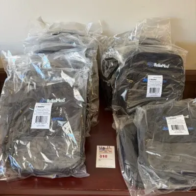 Lot of eleven ReliaMed black enteral feeding pump carrying bags, individually sealed in original plastic packaging.