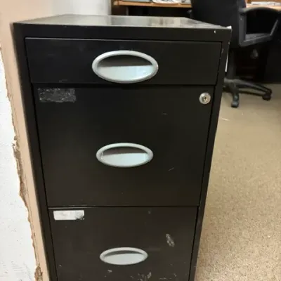 Black three-drawer metal vertical filing cabinet featuring oval recessed handles and a key lock.