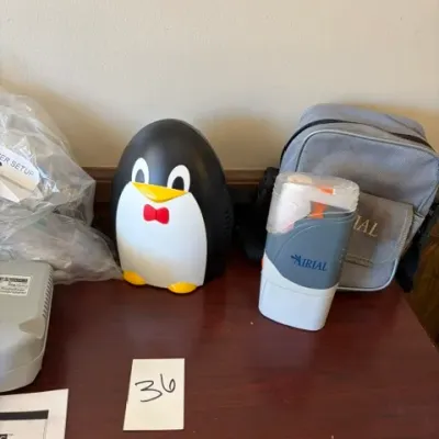 Airial pediatric penguin compressor nebulizer machine with carrying bag and accessories.