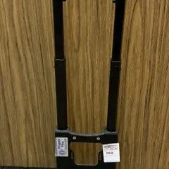 Black portable folding luggage cart with an extendable handle and two wheels, useful for transport or medical equipment.
