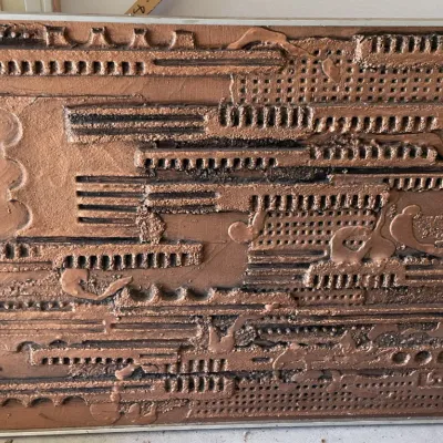 Sale Photo Thumbnail #40: Mid-century modern abstract brutalist relief wall sculpture with textured copper and bronze finish, housed in a thin metal frame.