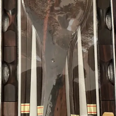 Sale Photo Thumbnail #91: Vintage Japanese ebony wood chopstick set including five pairs of chopsticks, matching rests, and a rice paddle, boxed in original packaging.