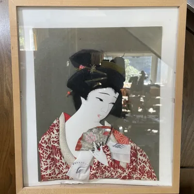 Sale Photo Thumbnail #68: Framed Japanese Oshie 3D fabric portrait of a geisha holding a fan, housed in a light wood shadowbox frame.