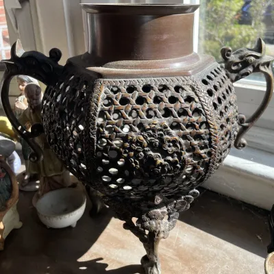 Sale Photo Thumbnail #33: Antique Asian reticulated bronze censer featuring intricate lattice body, floral details, and dragon-form side handles.