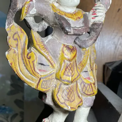 Sale Photo Thumbnail #99: Hand-carved and painted wooden figure of a Southeast Asian dancer, displaying chips and distressing consistent with age.