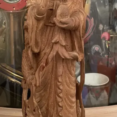 Sale Photo Thumbnail #75: Hand-carved wooden statue of Guanyin standing atop a dragon, featuring intricate robes and a serene expression.