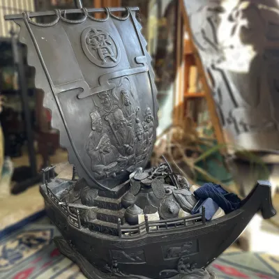 Sale Photo Thumbnail #36: Vintage Asian cast bronze or metal treasure ship (Takarabune) sculpture, featuring relief carvings of the Seven Lucky Gods on the sail and filled with symbolic treasures.