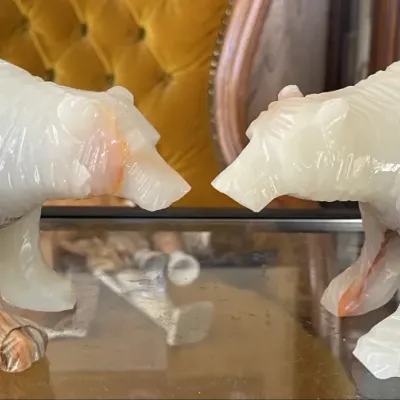Sale Photo Thumbnail #5: Pair of carved banded onyx or alabaster bear figurines facing each other, featuring cream and reddish-brown stone veining.