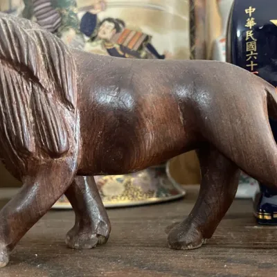 Sale Photo Thumbnail #173: Hand-carved wooden lion figurine depicting a roaring stance, featuring carved mane and tooth details.