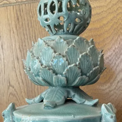 Sale Photo Thumbnail #15: Celadon glazed ceramic incense burner, featuring an intricate reticulated sphere atop a layered lotus flower base supported by small rabbit figures.