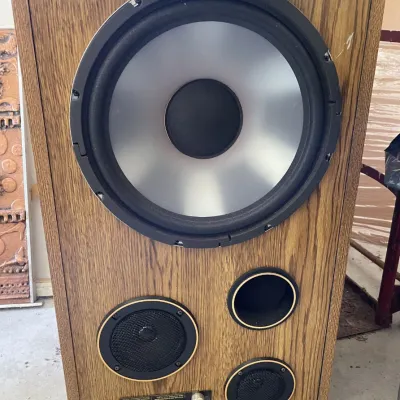 Sale Photo Thumbnail #41: Vintage Acoustic 520 liquid-cooled 3-way speaker cabinet featuring a silver cone woofer, mesh-covered drivers, and a wood grain finish.