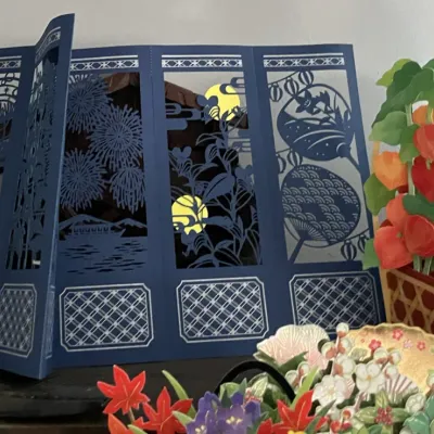 Sale Photo Thumbnail #104: Collection of decorative Japanese 3D pop-up greeting cards, including a dark blue laser-cut folding screen and a paper lantern plant arrangement.