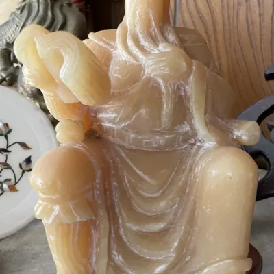 Sale Photo Thumbnail #18: Carved yellow soapstone statue depicting Guan Yu seated in traditional robes, mounted on a fitted wooden base.