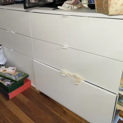 Sale Photo Thumbnail #64: Modern white six-drawer dresser featuring a minimalist handle design.
