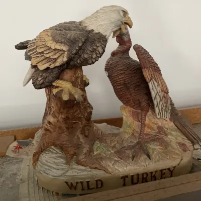 Sale Photo Thumbnail #114: Austin Productions resin figurine depicting a bald eagle attacking a wild turkey, resting on a rocky base labeled 'WILD TURKEY'.