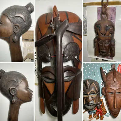 Sale Photo Thumbnail #209: Collection of hand-carved African style wooden masks and a bust carving featuring intricate details and geometric patterns.