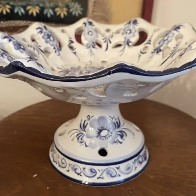 Sale Photo Thumbnail #156: Vintage blue and white glazed ceramic pedestal compote dish featuring reticulated cutouts and hand-painted floral motifs.