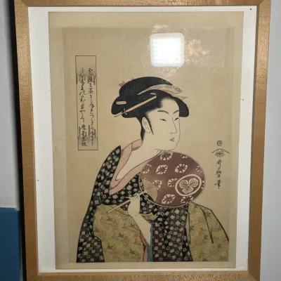 Sale Photo Thumbnail #57: Framed Japanese ukiyo-e woodblock print depicting a geisha holding a round fan, presented in a light wood frame.