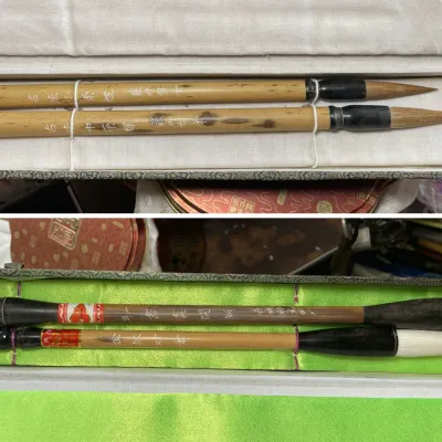 Sale Photo Thumbnail #195: Two boxed sets of traditional Chinese calligraphy brushes featuring natural bamboo handles with inscribed characters and white hair bristles.