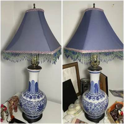 Sale Photo Thumbnail #207: Chinese-style blue and white porcelain table lamp featuring detailed floral motifs and a purple lampshade with beaded fringe trim.