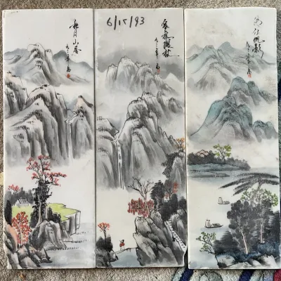 Sale Photo Thumbnail #96: Set of three vintage Chinese hand-painted porcelain landscape tiles featuring mountainous scenery, calligraphy inscriptions, and artist seals.