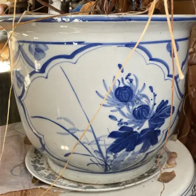 Sale Photo Thumbnail #38: Large Chinese blue and white porcelain fish bowl planter featuring floral motif panels and a matching drip saucer.