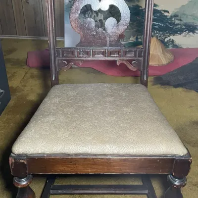 Sale Photo Thumbnail #51: Antique wooden dining chair with a decorative lyre back splat, turned front legs, and beige floral upholstered seat.