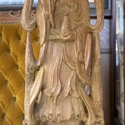 Sale Photo Thumbnail #10: Hand-carved wooden Guanyin figure standing on a lotus base and holding a flower stem, featuring intricate details in a traditional Asian style.