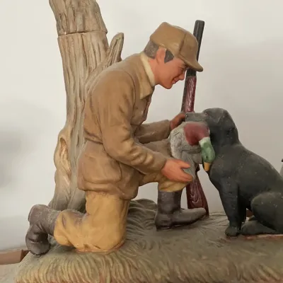 Sale Photo Thumbnail #116: Vintage ceramic decanter featuring a hunter with his dog and a duck, titled 'Good Boy!', showing minor surface wear.