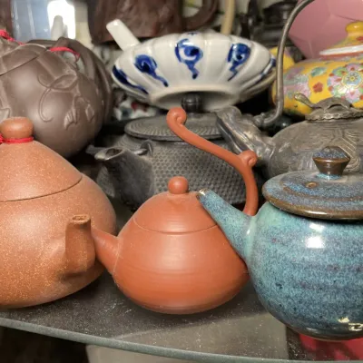 Sale Photo Thumbnail #122: Collection of Asian ceramic, yixing zisha clay, and cast iron teapots in various styles and finishes.