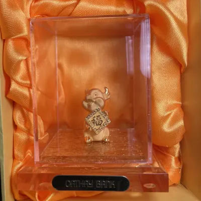 Sale Photo Thumbnail #123: Cathay Bank Chinese Zodiac miniature gold-tone ox figurine, housed in an acrylic display case with an orange satin-lined gift box.