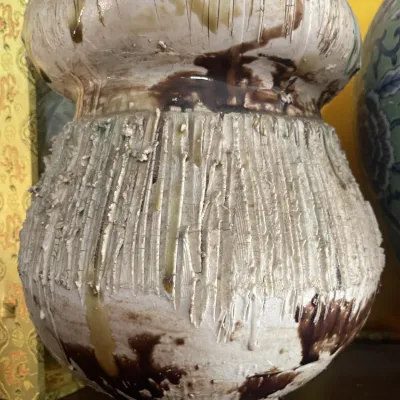 Sale Photo Thumbnail #179: Studio pottery ceramic vessel featuring a heavily textured, bark-like exterior finish with dripping brown and tan glazes.