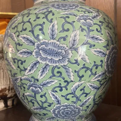 Sale Photo Thumbnail #178: Chinese ceramic temple jar vase featuring blue floral and leafy vine motifs over a celadon green ground.