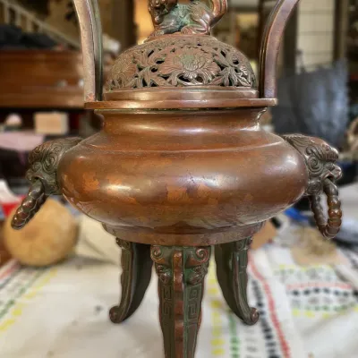 Sale Photo Thumbnail #23: Antique Asian bronze tripod incense burner with a foo dog finial lid, floral reticulated cover, and side handles with ring pulls.