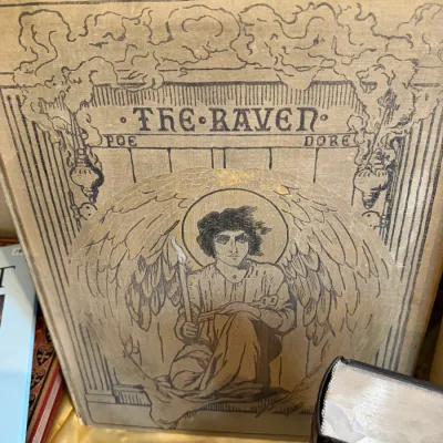 Sale Photo Thumbnail #75: 1884 (First Edition) Antique folio edition of Edgar Allan Poe's "The Raven," illustrated by Gustave Doré, featuring a cloth cover with elaborate cover illustration.