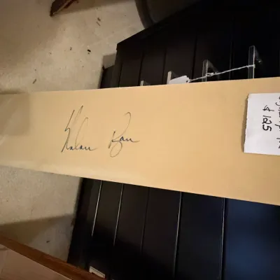 Sale Photo Thumbnail #43: Autographed Nolan Ryan wooden plaque or signature piece, displayed with price tag.