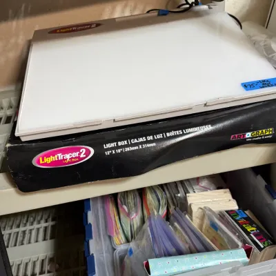 Sale Photo Thumbnail #307: Artograph LightTracer 2 light box measuring 12" x 18", sitting on its original packaging box.