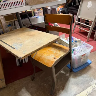 Sale Photo Thumbnail #375: Vintage wood and metal student desk combo with an attached chair, showing light wear and paint marks from use.