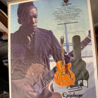 Sale Photo Thumbnail #99: Epiphone advertisement print featuring the John Lee Hooker Limited Edition 100th Anniversary Zephyr Outfit, protected in clear plastic sleeve.