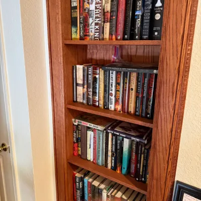 Sale Photo Thumbnail #22: large collection of hardcover and paperback books, featuring titles by Stephen King and Ted Bell.