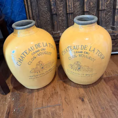 Sale Photo Thumbnail #145: Pair of yellow glazed ceramic French wine jars, featuring black text and graphic for Chateau De La Tour Clos-Vougeot.