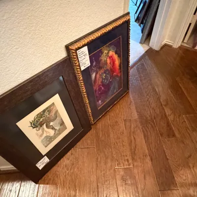 Sale Photo Thumbnail #243: Two framed art prints by Salvador Dalí, including one with a ornate gilded frame and deep blue matting.