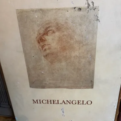 Sale Photo Thumbnail #77: Vintage Michelangelo art book or portfolio case featuring a sketch print on the front cover with visible wear to the edges.