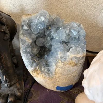 Sale Photo Thumbnail #141: Large light blue celestite crystal geode with a natural rough rock exterior.